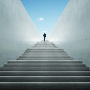 man walking up a staircase undergoing a breakthrough process