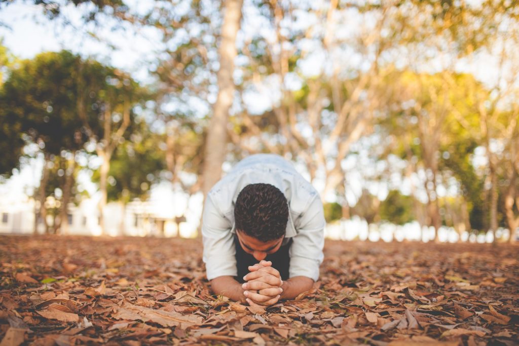 man praying on the floor