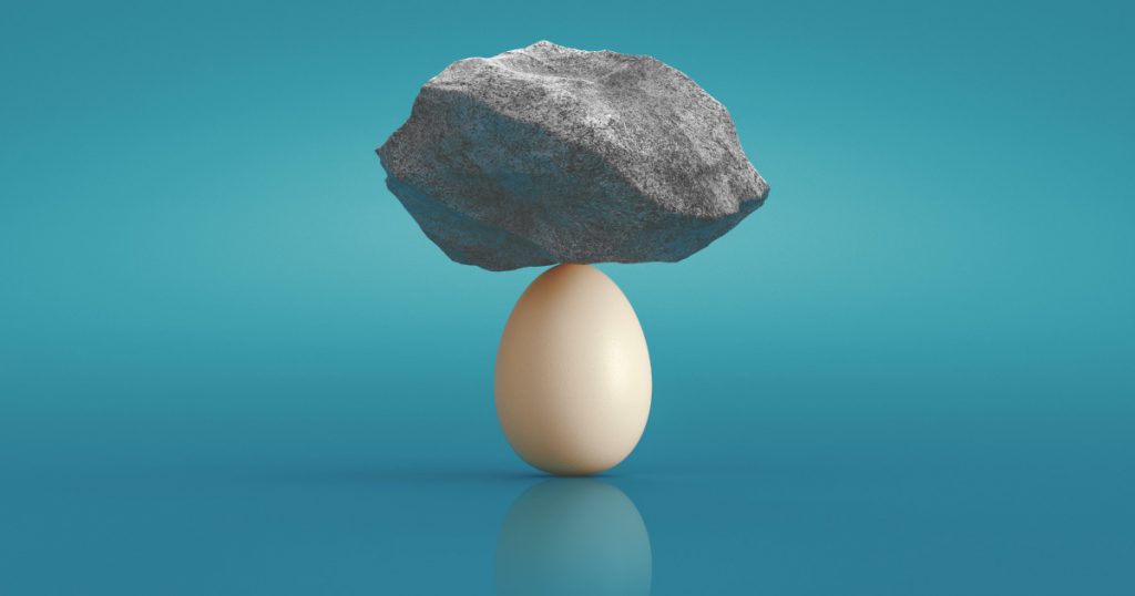 stone balancing on egg